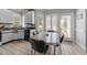 Cozy breakfast nook featuring bright light from the large window and stylish retro kitchen table at 7605 Pats Branch Dr, Raleigh, NC 27612