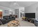 Spacious living room featuring sleek furniture, neutral colors, and a seamless flow to the kitchen at 7605 Pats Branch Dr, Raleigh, NC 27612
