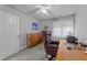 Home office with carpet, built-in cabinets, window, and traditional wooden desk at 7605 Pats Branch Dr, Raleigh, NC 27612