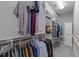 Organized walk-in closet with hanging rods, shelves, and ample storage space at 7605 Pats Branch Dr, Raleigh, NC 27612