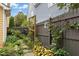 Lush backyard garden featuring decorative fence, stone path, and mature plants at 800 Highgrove Dr, Chapel Hill, NC 27516
