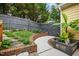 Serene backyard garden featuring brick planters, custom fence, and lush greenery at 800 Highgrove Dr, Chapel Hill, NC 27516