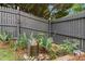 Charming backyard garden with a stone fountain and a gray wooden privacy fence at 800 Highgrove Dr, Chapel Hill, NC 27516