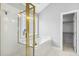 Bathroom features a jacuzzi tub with shower, white tile, and gold trim at 800 Highgrove Dr, Chapel Hill, NC 27516