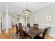 Elegant dining room featuring a large wooden table, hardwood floors, and ample natural light at 800 Highgrove Dr, Chapel Hill, NC 27516
