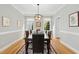 A bright dining room features a wood floor, white walls with a large table and decorative rug at 800 Highgrove Dr, Chapel Hill, NC 27516
