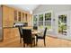 A dining area with built-in cabinets and a round table with chairs, next to a backyard view at 800 Highgrove Dr, Chapel Hill, NC 27516