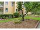 Home exterior featuring a tree-lined yard, brick accents, and lush, green landscaping at 800 Highgrove Dr, Chapel Hill, NC 27516