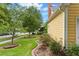 Home exterior with manicured front lawn, mature trees, and attractive brick-lined garden beds at 800 Highgrove Dr, Chapel Hill, NC 27516