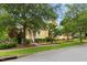 View of a charming yellow house featuring a well-maintained lawn and lush landscaping on a sunny day at 800 Highgrove Dr, Chapel Hill, NC 27516