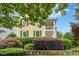 Charming yellow home with green shutters and lush landscaping, creating a welcoming and inviting curb appeal at 800 Highgrove Dr, Chapel Hill, NC 27516