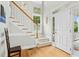 Bright foyer featuring hardwood floors, a staircase with white railings, and a charming window at 800 Highgrove Dr, Chapel Hill, NC 27516