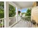 Charming covered front porch with seating area and decorative hanging plants at 800 Highgrove Dr, Chapel Hill, NC 27516