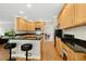An open kitchen features light wood cabinetry, granite countertops, and stainless steel appliances at 800 Highgrove Dr, Chapel Hill, NC 27516