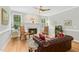Bright living room featuring hardwood floors, a fireplace, and leather furniture near large windows at 800 Highgrove Dr, Chapel Hill, NC 27516