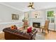 A cozy living room featuring hardwood floors, fireplace, and comfortable leather furniture at 800 Highgrove Dr, Chapel Hill, NC 27516