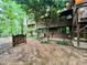Landscaped backyard featuring a small wooden gate, greenery, and plenty of shade at 808 Indian Springs Rd, Chapel Hill, NC 27514