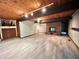 Finished basement with tile flooring, a brick fireplace, and wood paneled ceiling at 808 Indian Springs Rd, Chapel Hill, NC 27514