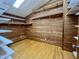 Walk-in closet with wooden walls, hardwood floors, and plenty of shelving space at 808 Indian Springs Rd, Chapel Hill, NC 27514
