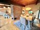 Charming dining area with wood floors, brick accent wall, and natural light creating an inviting atmosphere at 808 Indian Springs Rd, Chapel Hill, NC 27514