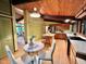 Open kitchen with island, eat-in table, wood ceilings, and plenty of natural light at 808 Indian Springs Rd, Chapel Hill, NC 27514