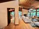 Bright living room featuring hardwood floors, a brick fireplace, and large windows showcasing the natural landscape at 808 Indian Springs Rd, Chapel Hill, NC 27514