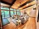 Inviting living area features hardwood floors, brick fireplace, and large windows overlooking a serene outdoor setting at 808 Indian Springs Rd, Chapel Hill, NC 27514