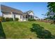 Backyard view featuring lush green lawn, mature landscaping, and a screened-in porch at 857 Mill Station Ln, Wendell, NC 27591