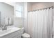 Bright bathroom features a sink with vanity and shower with curtain at 857 Mill Station Ln, Wendell, NC 27591