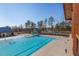 Community pool with a slide, splash pad, lounge chairs, and shade at 857 Mill Station Ln, Wendell, NC 27591