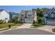 Charming two-story home boasts a welcoming front porch with rocking chairs and a well-manicured lawn at 857 Mill Station Ln, Wendell, NC 27591