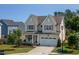 Charming two-story home boasts a welcoming front porch with rocking chairs and a well-manicured lawn at 857 Mill Station Ln, Wendell, NC 27591
