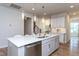 Close-up of the kitchen island featuring a stainless steel sink and barstool seating at 857 Mill Station Ln, Wendell, NC 27591