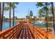 Beautiful view of a lake with a fountain and a wooden pier surrounded by lush greenery and neighborhood homes at 857 Mill Station Ln, Wendell, NC 27591