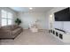 Cozy living room with plush carpet, comfortable seating, and a large screen television at 857 Mill Station Ln, Wendell, NC 27591