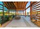 Spacious outdoor patio featuring wood beams, ample seating, and a cozy fireplace for year-round entertaining at 857 Mill Station Ln, Wendell, NC 27591