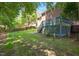 Serene backyard with a wooden deck, lush greenery, and a classic wooden fence at 904 Oldwyck Dr, Fuquay Varina, NC 27526