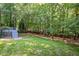 Expansive backyard featuring lush lawn, mature trees, and a charming deck at 904 Oldwyck Dr, Fuquay Varina, NC 27526