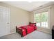 Bedroom featuring neutral walls, one bed with a red comforter, and a window at 904 Oldwyck Dr, Fuquay Varina, NC 27526