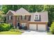 Attractive brick home with black shutters, arched windows, mature landscaping, and a two-car garage at 904 Oldwyck Dr, Fuquay Varina, NC 27526
