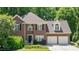 Charming brick home featuring manicured landscaping, a two-car garage, and classic architectural details at 904 Oldwyck Dr, Fuquay Varina, NC 27526