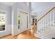 Bright and airy foyer features hardwood floors, a staircase with wood railing, and transom windows at 904 Oldwyck Dr, Fuquay Varina, NC 27526