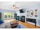 Inviting living room with a fireplace, hardwood floors, an area rug, and large windows at 904 Oldwyck Dr, Fuquay Varina, NC 27526