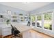 Well-lit office features custom built-ins, a spacious desk, and ample natural light from multiple windows at 904 Oldwyck Dr, Fuquay Varina, NC 27526