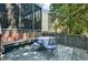 Outdoor back deck with table, seating, and latticework, perfect for entertaining guests at 908 Town Side Dr, Apex, NC 27502