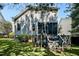 Back exterior of home with screened porch, deck, and well-maintained lawn at 908 Town Side Dr, Apex, NC 27502