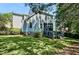 Rear view of home with screened porch, deck, fenced yard, and mature trees at 908 Town Side Dr, Apex, NC 27502