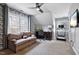 Well-lit bedroom with a bookshelf wallpaper accent, a sofa, desk, and treadmill at 908 Town Side Dr, Apex, NC 27502