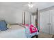 Bedroom with a 4 post bed, ceiling fan, and a staircase leading to another floor at 908 Town Side Dr, Apex, NC 27502
