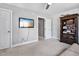 Bedroom with a ceiling fan, television, wooden bookshelf, and neutral color theme at 908 Town Side Dr, Apex, NC 27502